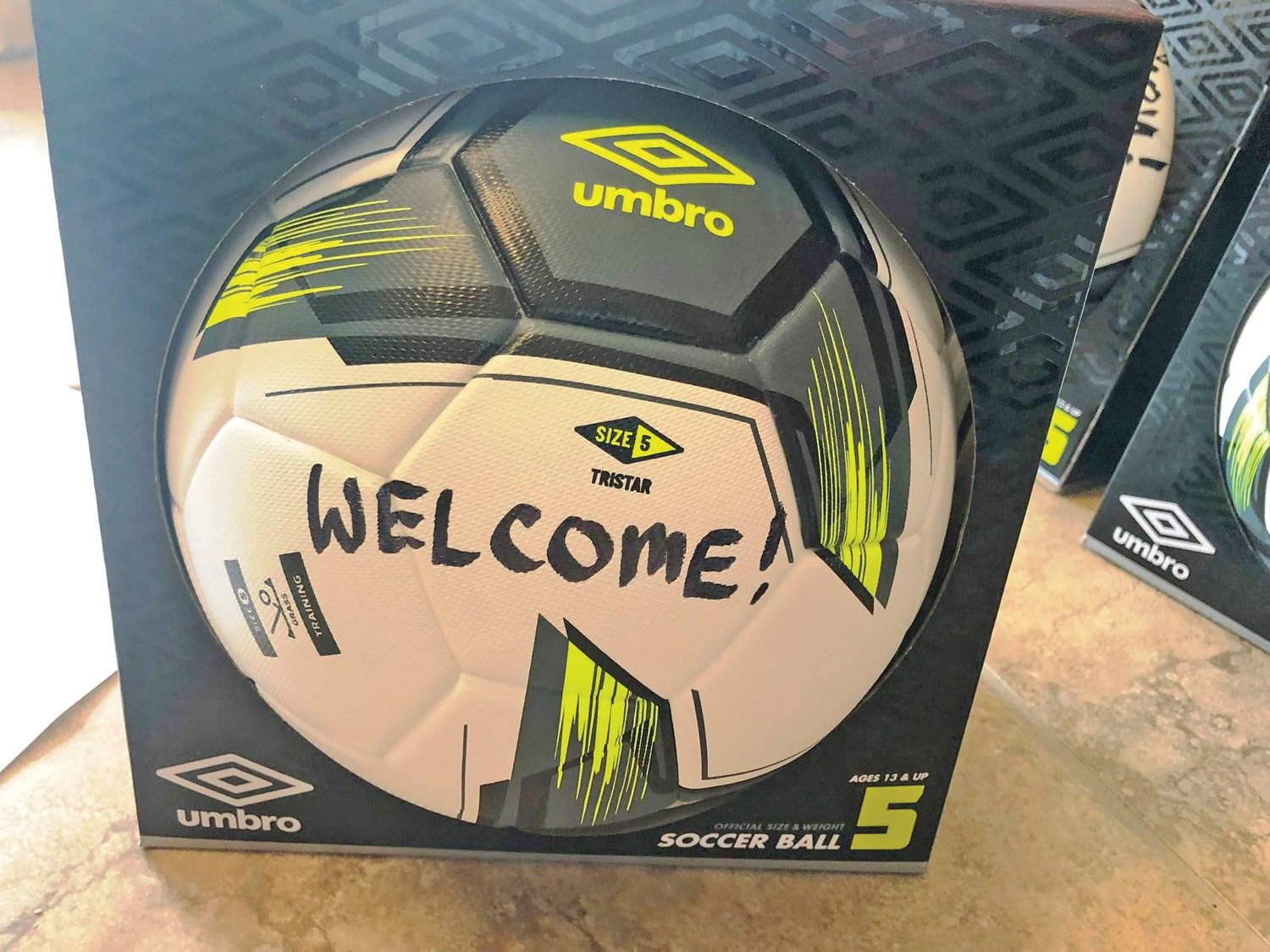 A message welcoming Afghan refugees is written on a soccer ball delivered to Camp Atterbury.